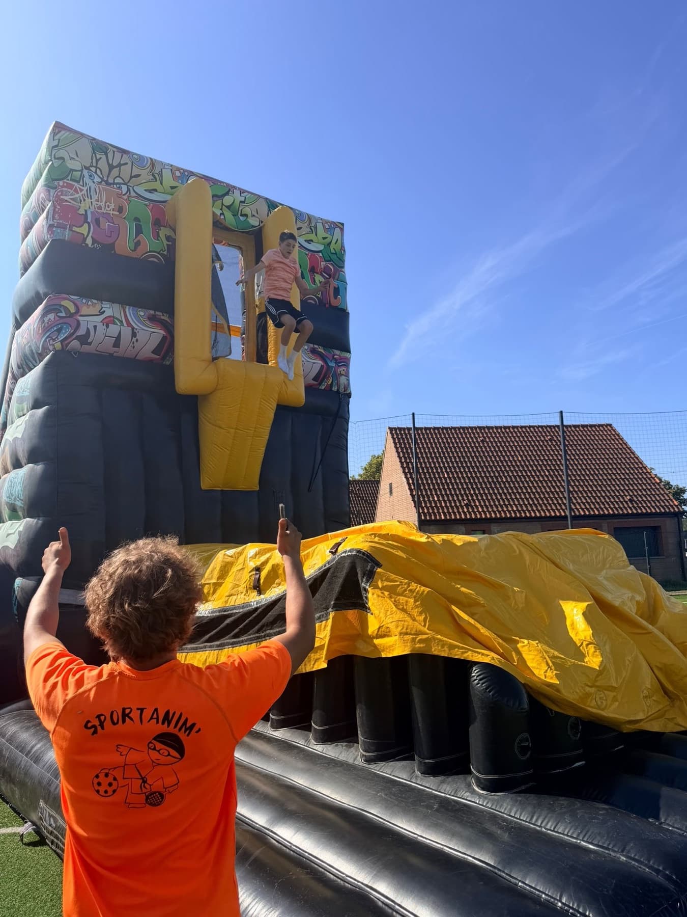 Enfant sautant sur un parcours gonflable de type street lors d'une animation.